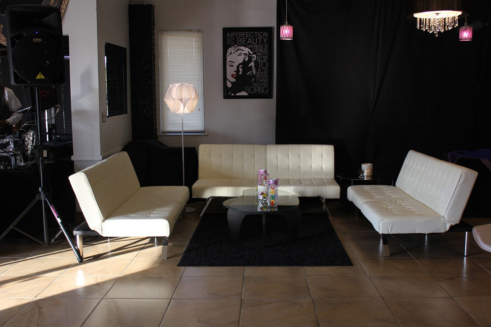 White lounge sofas and coffee table at an event